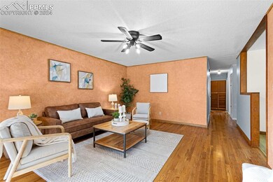 Living room with light hardwood / wood-style floor