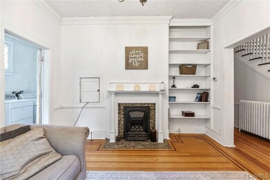 Living room with ornamental molding, hardwood / wo