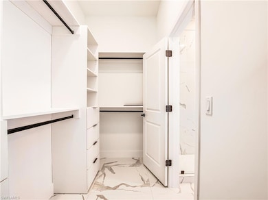 Spacious closet with light marble finish flooring