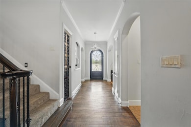 Entrance foyer featuring stairway, baseboards, orn
