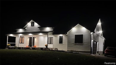 Modern inspired farmhouse featuring covered porch, a front yard, and roof with shingles