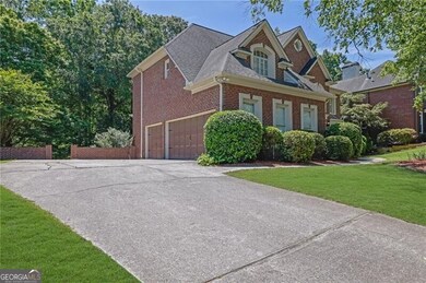 View of front of home featuring driveway, roof wit