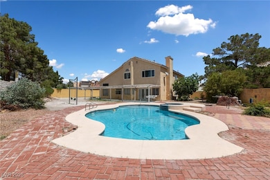 View of pool with a patio, fence, and a pool with