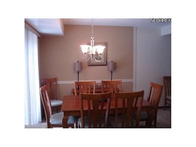 Dining Room with new chandelier. Sliders to the pa