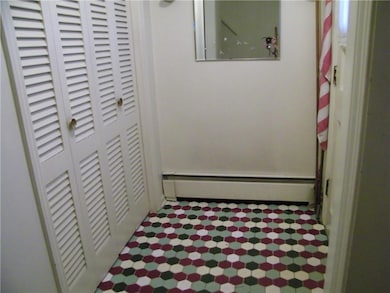 The front entry has a colorful tiled floor and a d