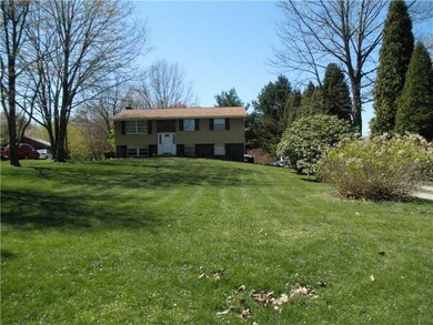 Exterior Front. Level .93 acres. Trees and floweri