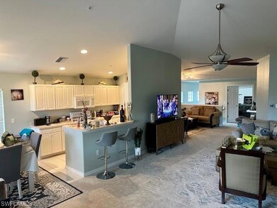 Kitchen with light carpet, white microwave, a kitc