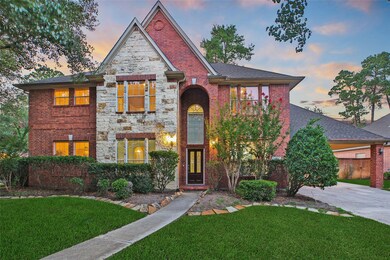This charming two-story brick home features a blend of brick and stone accents, a welcoming arched entryway, and well-maintained landscaping. The driveway leads to a spacious garage, and the property is surrounded by mature trees, offering a serene and private setting.