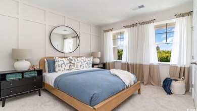 Carpeted bedroom featuring multiple windows
