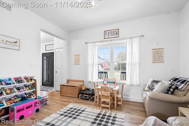 Recreation room featuring light wood-style flooring and baseboards