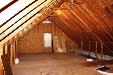 Attic space open. Has stairs leading up to space.