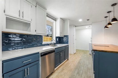 A stylish backsplash and modern lighting elevate t