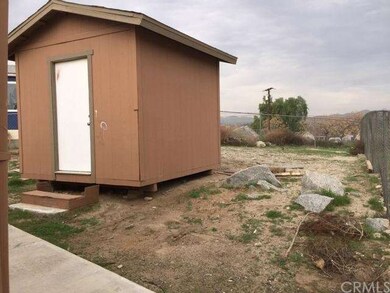Backyard features a storage shed