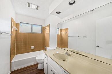 Bathroom featuring a textured ceiling, shower / t