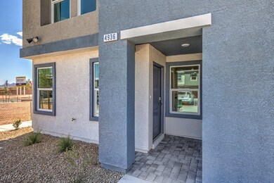 Property entrance with stucco siding and fence