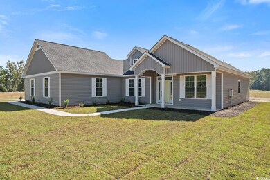View of front facade with a front yard and a porch