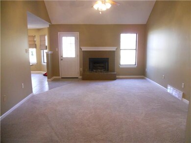 Large room with new carpet and fresh paint.  Kitchen/breakfast area to the left. Door leads to the back yard.