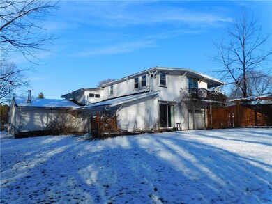 The back of this home as seen from the treeline.