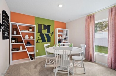 Carpeted dining room with baseboards