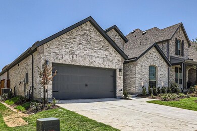 View of front of house featuring a garage and cooling unit