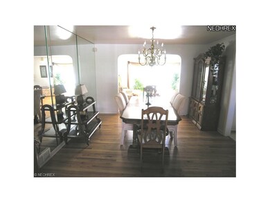 Formal Dining Room with hardwood flooring and bras