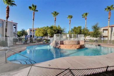 Community pool with a patio and a residential view