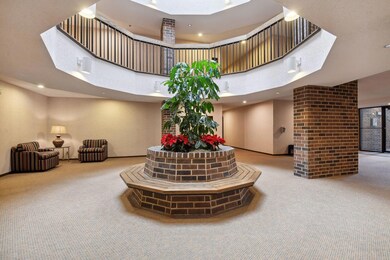 Enter into a spacious lobby where you can find your mail, announcements and the elevator.  This condo is on the main floor.   There is a second entrance and parking conveniently located right next to this condo.