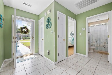 Entryway featuring light tile patterned flooring and baseboards