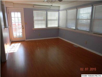 COZY, LARGE GLASSED, HEATED AND COOLED SUNROOM.