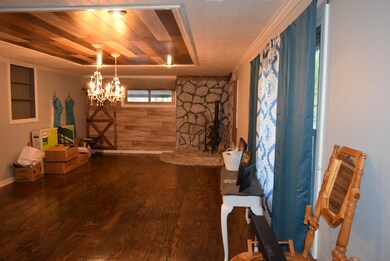  Large living room with beautiful wood accents on the ceiling and the wall. 