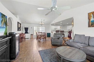 Living area with arched walkways, lofted ceiling,