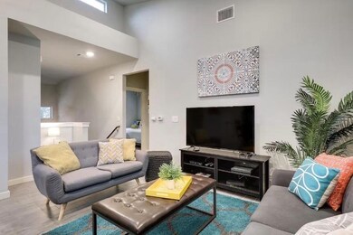 Living room featuring a towering ceiling, baseboa