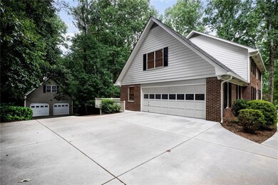 View of home's exterior featuring brick siding, an attached garage, and driveway