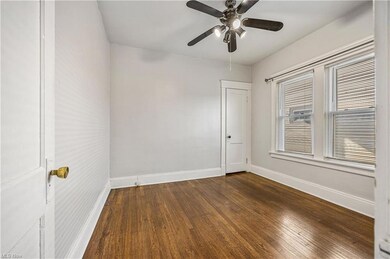 Spare room with hardwood flooring and ceiling fan