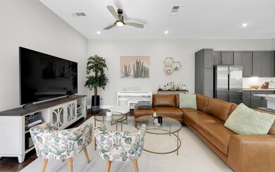 Living area featuring visible vents, wood finishe