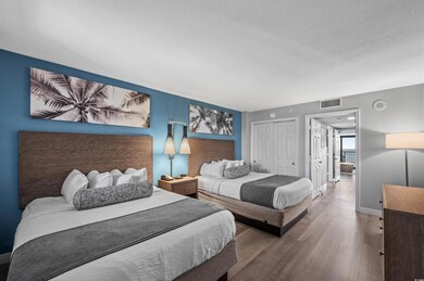 Bedroom featuring a closet, a textured ceiling, and hardwood / wood-style flooring
