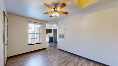 Spare room featuring a textured ceiling, dark hard