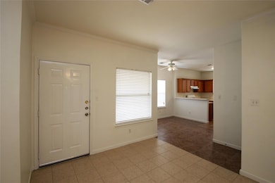 Foyer entrance with baseboards, a ceiling fan, an