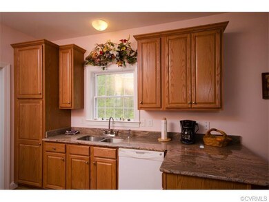 The kitchen has wood cabinetry, granite counter tops, an undermount sink and opens to the eating area.