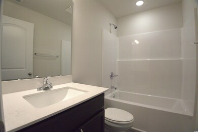 Bathroom with tub / shower combination, vanity, and recessed lighting