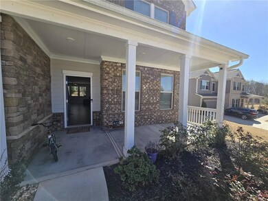 View of exterior entry with stone siding and a por