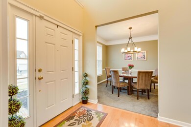 Entry with wood flooring connected to great room, dining room and den.