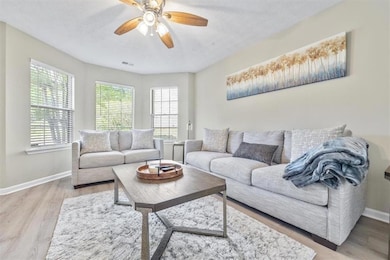 Living room featuring a textured ceiling, light wo