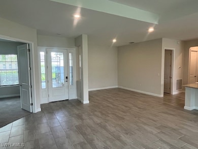 Entrance foyer with baseboards, recessed lighting,