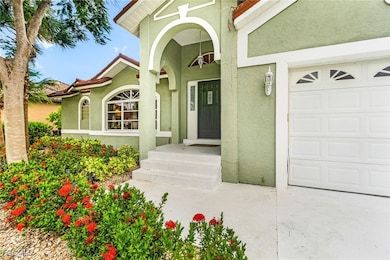View of exterior entry featuring a tiled roof, stucco siding, and an attached garage