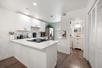 Kitchen with stainless steel refrigerator with ic