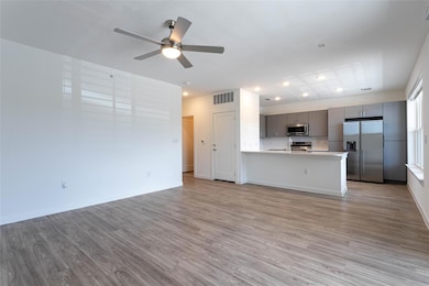 Unfurnished living room with wood finished floors