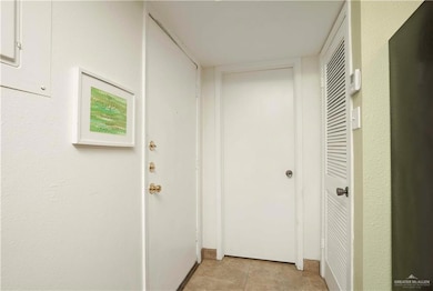 Hallway featuring light tile patterned flooring