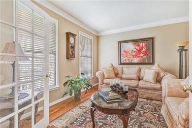 Formal living room with French doors, crown moldin