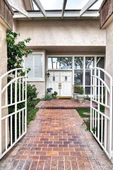 Enter through an elegant brick lined gated courtya